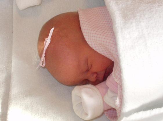 The nurses put a little bow on her head (notice I didn't say in her hair - she doesn't really have any). :):)