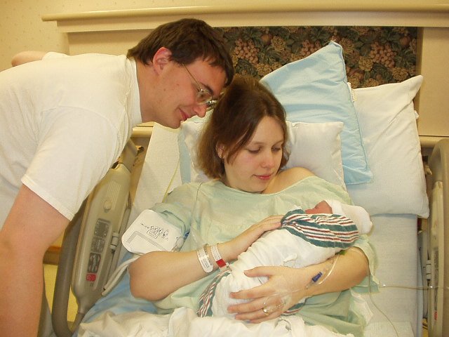 My first picture with Daddy and Mommy.
