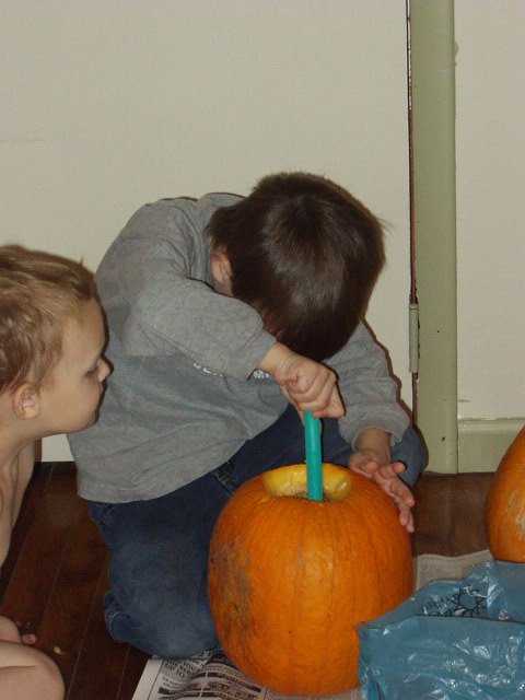 Timothy is helping Elijah get all of the seeds out.