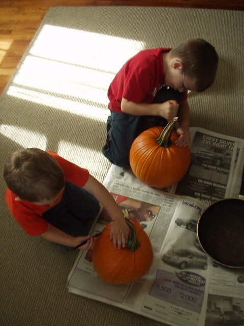 Timothy is starting with the lid. Elijah is drawing on the face :)