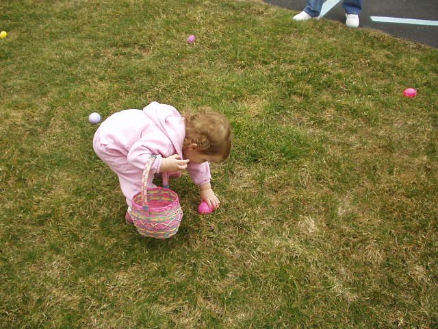 Abigail looks like a little old lady picking up eggs :)