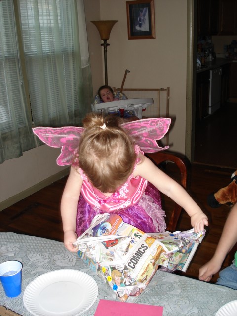 Abby was a little too excited about her presents to waste any time eating.