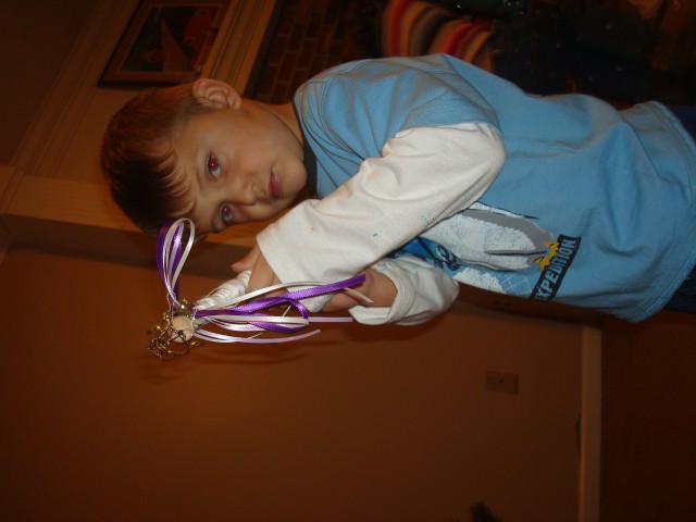 That's an awful tough look for a boy holding an Angel ornament :P