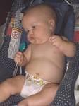 Mary was trying to sing with her spoon.  (looks like she is trying to snap her fingers also)
