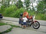 Elijah is telling Nicholas how you ride a motorcycle :)
