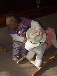 Abigail is letting her neigh-neigh try on the hat that Aunt Joni bought (for Abigail):)