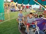 Elijah is too cool for the kiddie motorcycle.